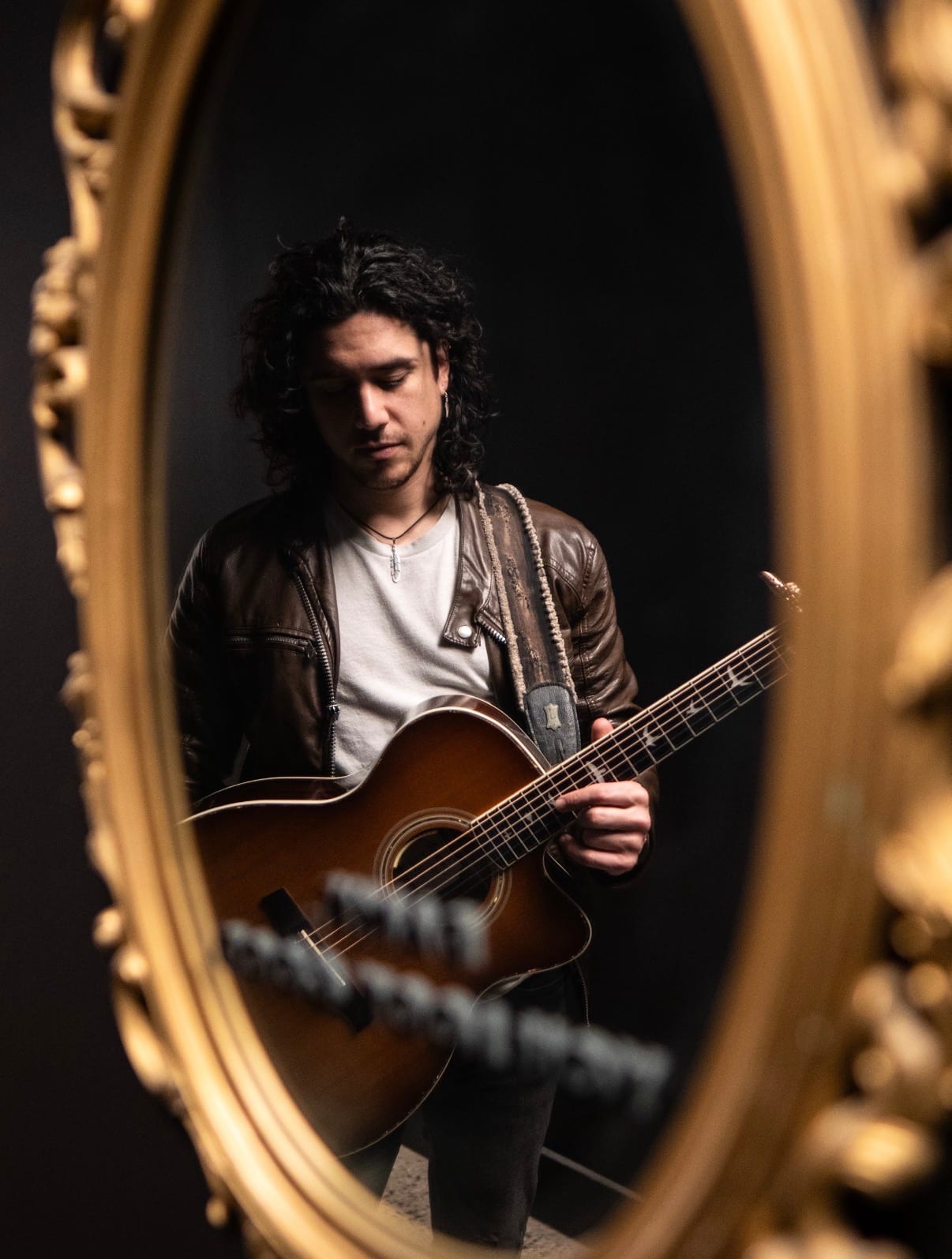 anthony and his acoustic guitar. Black and gold scene